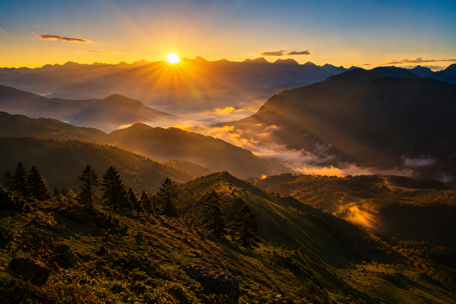 A cinematic panoramic shot showing the first golden sunbeams of the earliest sunrise in India breaking over sharp mountain ridges in Dong Valley under a clear sky."