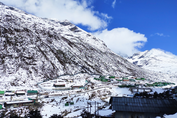 Snow-capped Himalayan peaks under a blue sky on the Twang road.