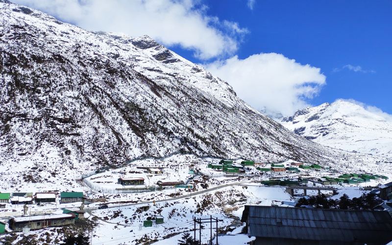 Snow-capped Himalayan peaks under a blue sky on the Twang road.