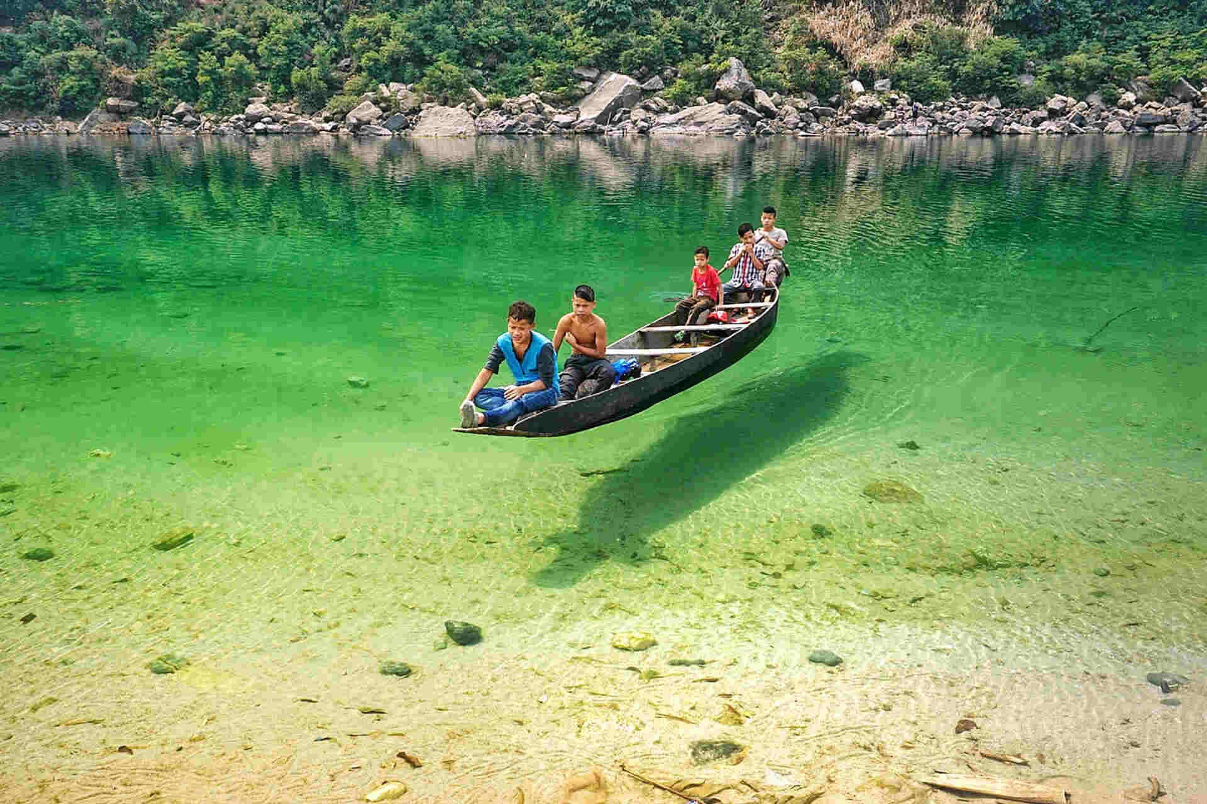 Boat on the clear green Umngot river at Dawki, Meghalaya