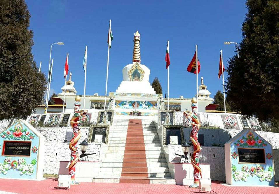 The stupa-style Tawang War Memorial against a clear blue Himalayan sky.