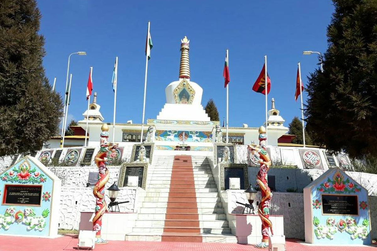 The stupa-style Tawang War Memorial against a clear blue Himalayan sky.