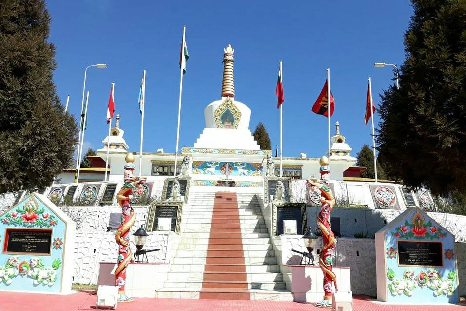 The stupa-style Tawang War Memorial against a clear blue Himalayan sky.