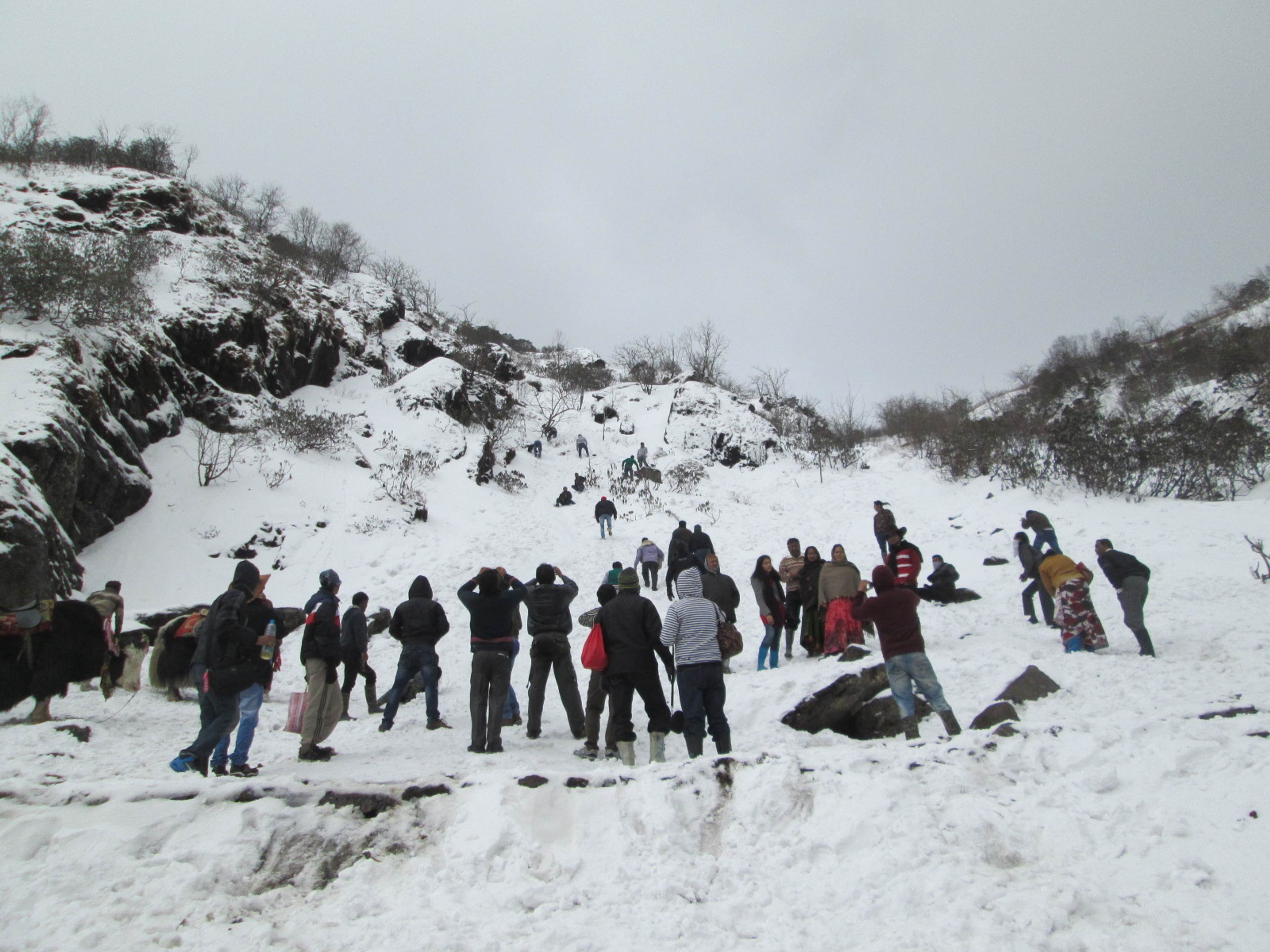 Visitors in the snow at Tsomgo Lake