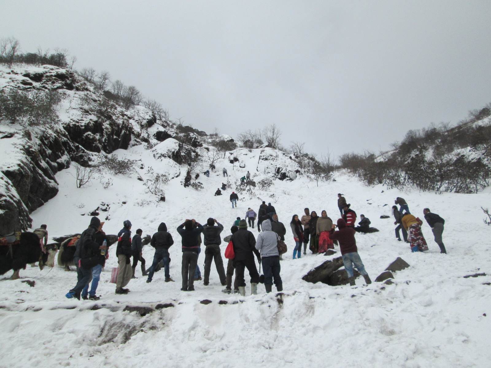 Visitors in the snow at Tsomgo Lake