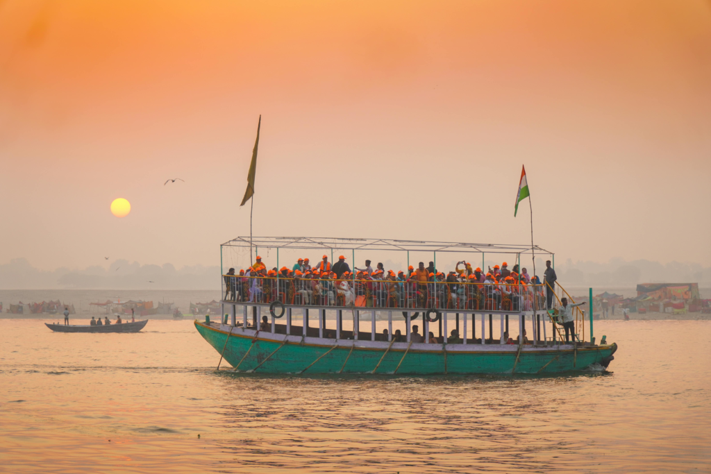 Wooden ferry boat crossing the Brahmaputra river towards Majuli island at sunrise