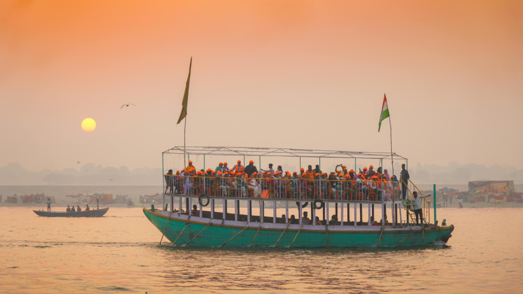 Wooden ferry boat crossing the Brahmaputra river towards Majuli island at sunrise