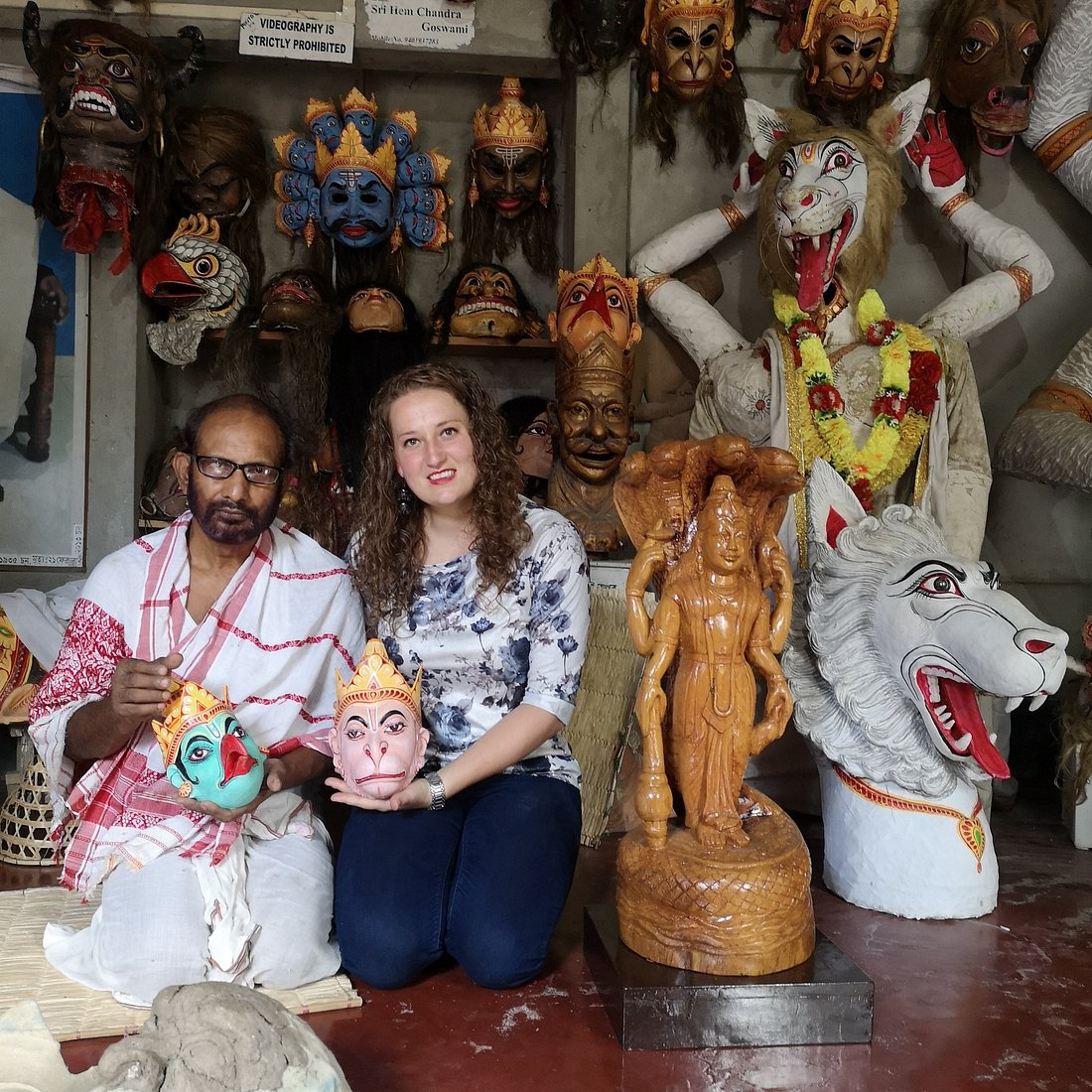 Artisan painting a large traditional mask at Samaguri Satra on Majuli island