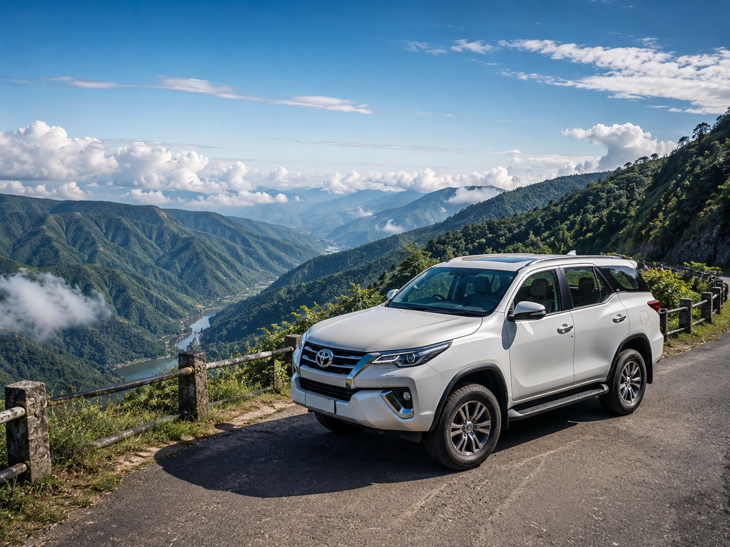A luxury white SUV vehicle parked safely at a panoramic mountain road overlook in the Khasi Hills of Meghalaya."