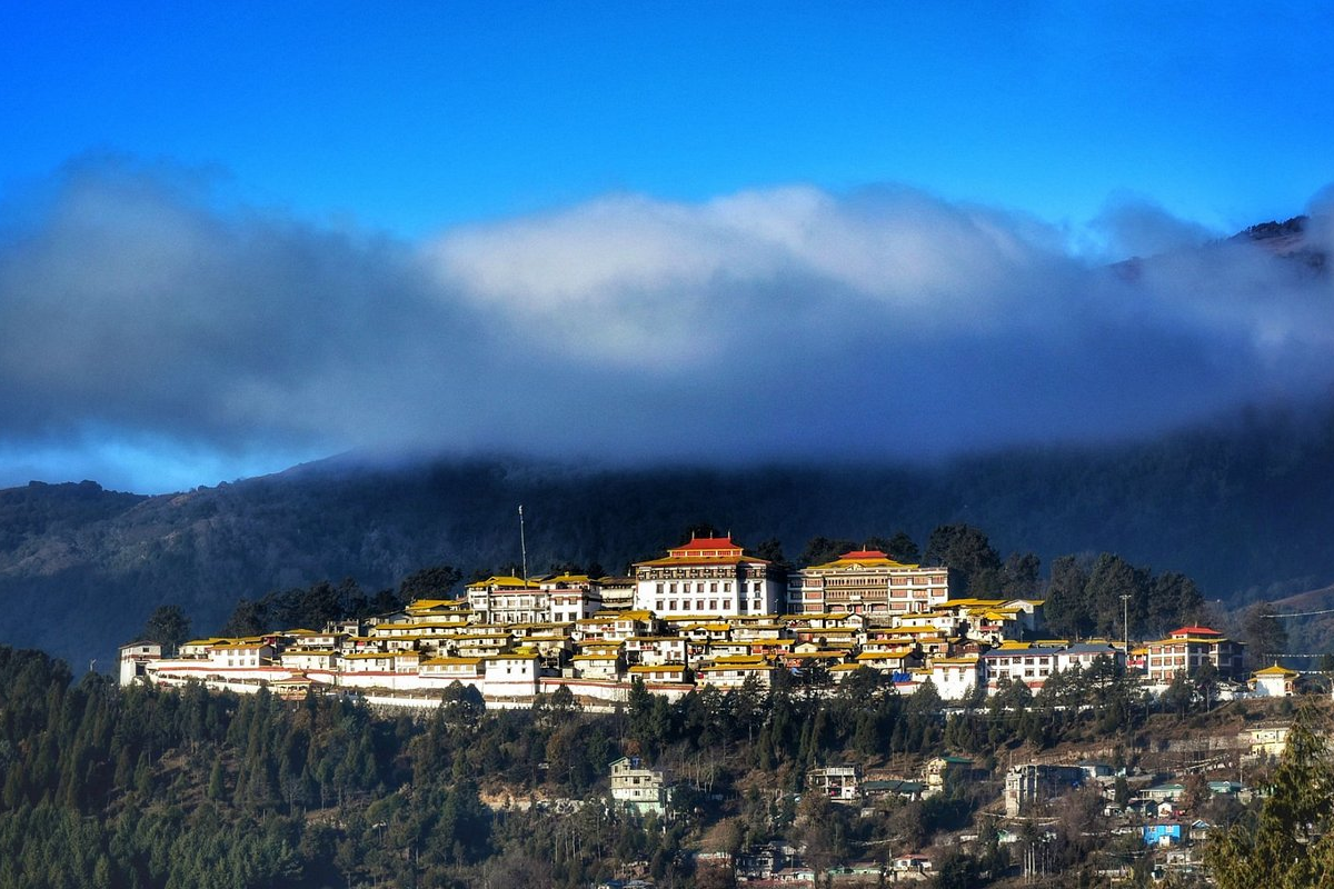 Tawang Monastery perched on a hilltop surrounded by mountains and mist in Arunachal Pradesh