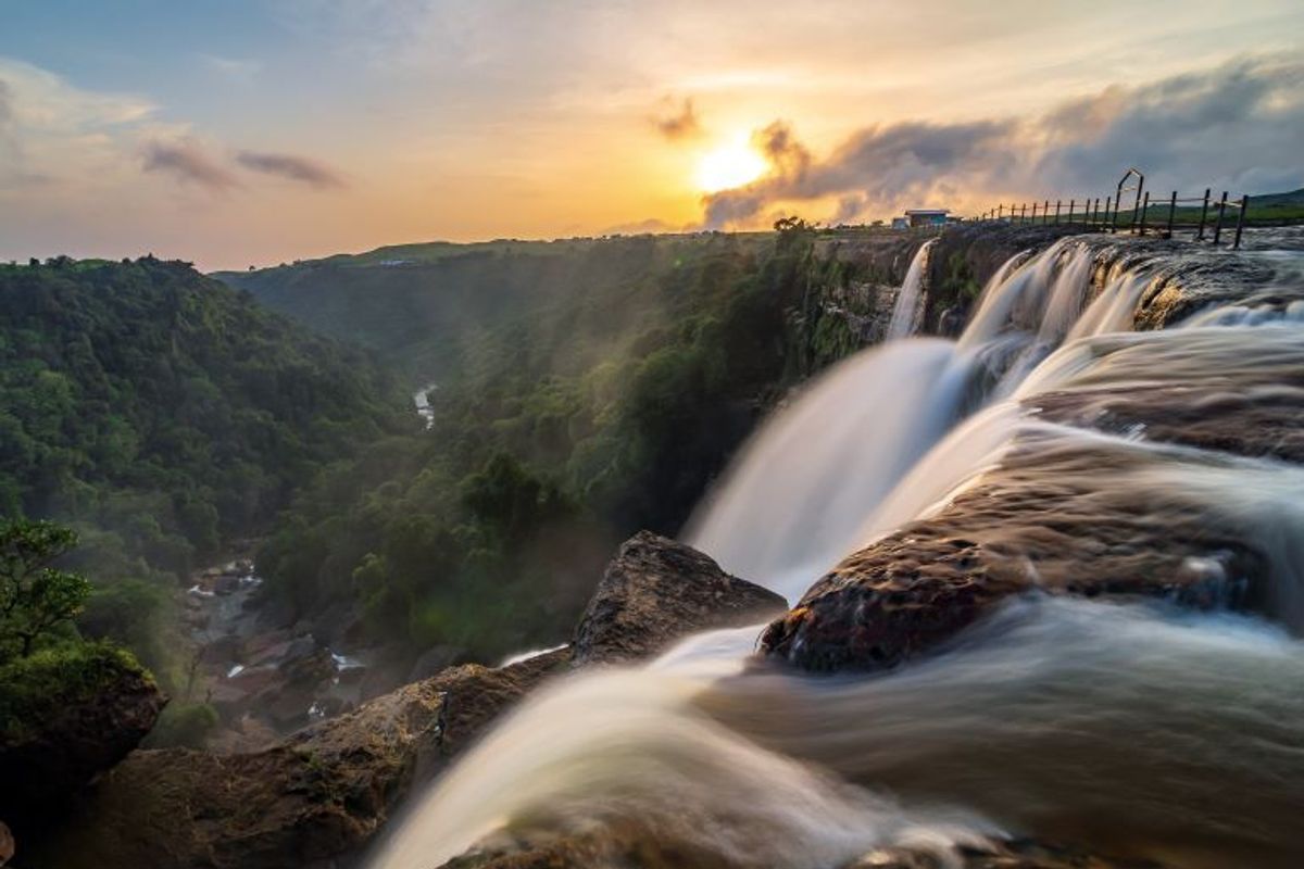 Wide horizontal Dainthlen Falls in Sohra Meghalaya showing the rocky riverbed and deep gorge.