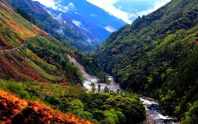 Mountain valley with river and misty slopes in Arunachal Pradesh, highlighting Mechuka and nearby destinations