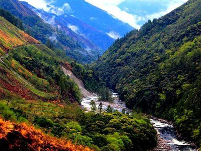 Mountain valley with river and misty slopes in Arunachal Pradesh, highlighting Mechuka and nearby destinations
