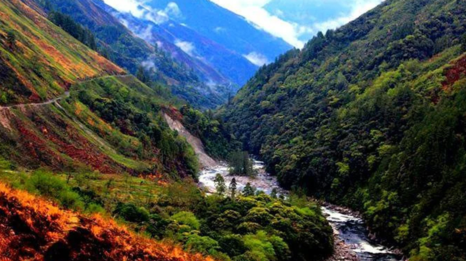 Mountain valley with river and misty slopes in Arunachal Pradesh, highlighting Mechuka and nearby destinations