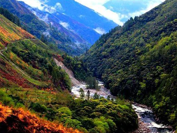 Mountain valley with river and misty slopes in Arunachal Pradesh, highlighting Mechuka and nearby destinations