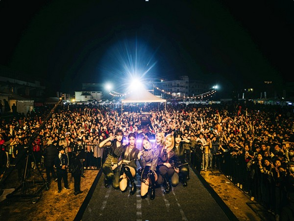 Crowd facing the main stage at the Shillong Cherry Blossom Festival at night with stage lights