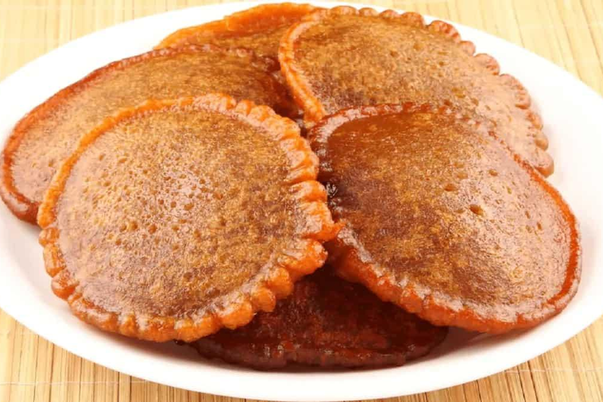 Pukhlein sweet fried rice bread made with jaggery in Meghalaya