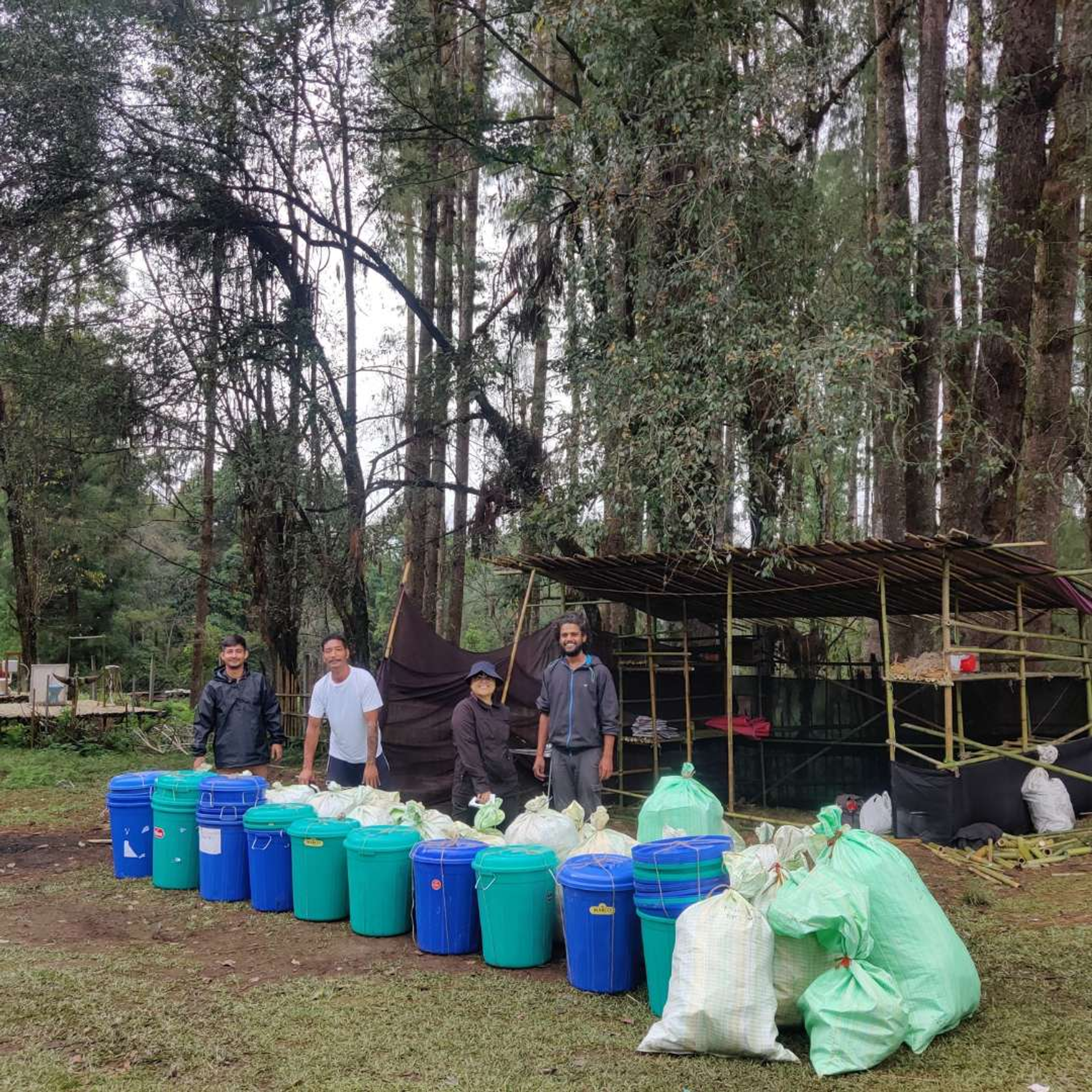 Volunteers in green vests sorting eco-friendly waste during the Ziro Festival of Music.