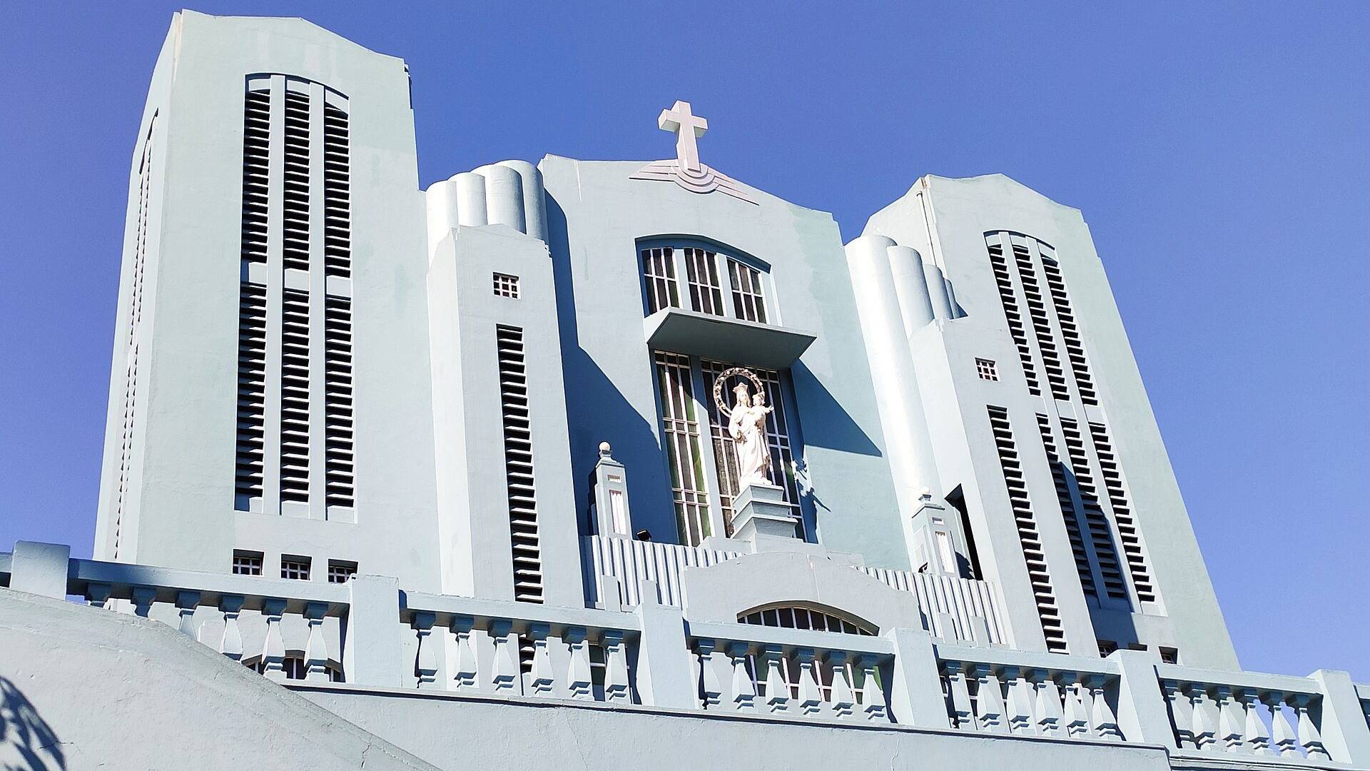 The pale blue Cathedral of Mary Help of Christians in Laitumkhrah, Shillong, on a clear winter day