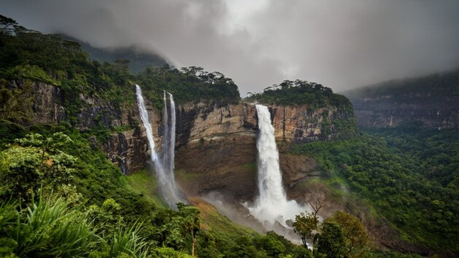 Traditional Khasi dancers in Smit, Meghalaya, wearing silver quivers and gold crowns during the Nongkrem Dance Festival.