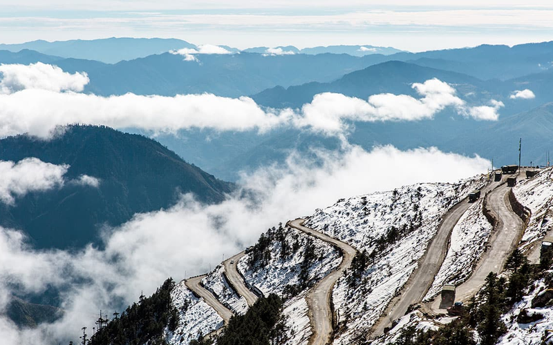 The winding mountain roads of Sela Pass leading toward Tawang, Arunachal Pradesh.