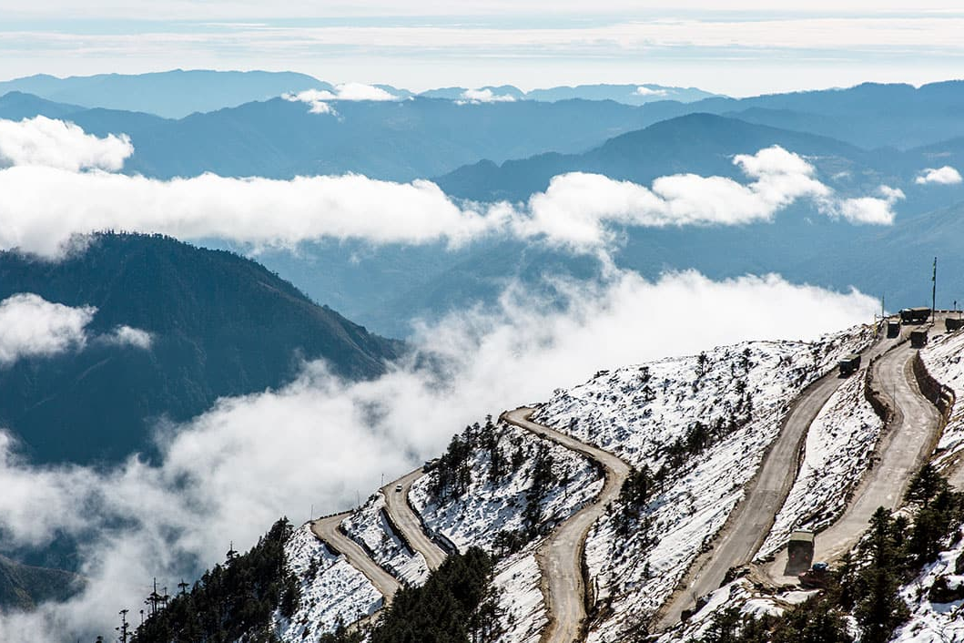 The winding mountain roads of Sela Pass leading toward Tawang, Arunachal Pradesh.
