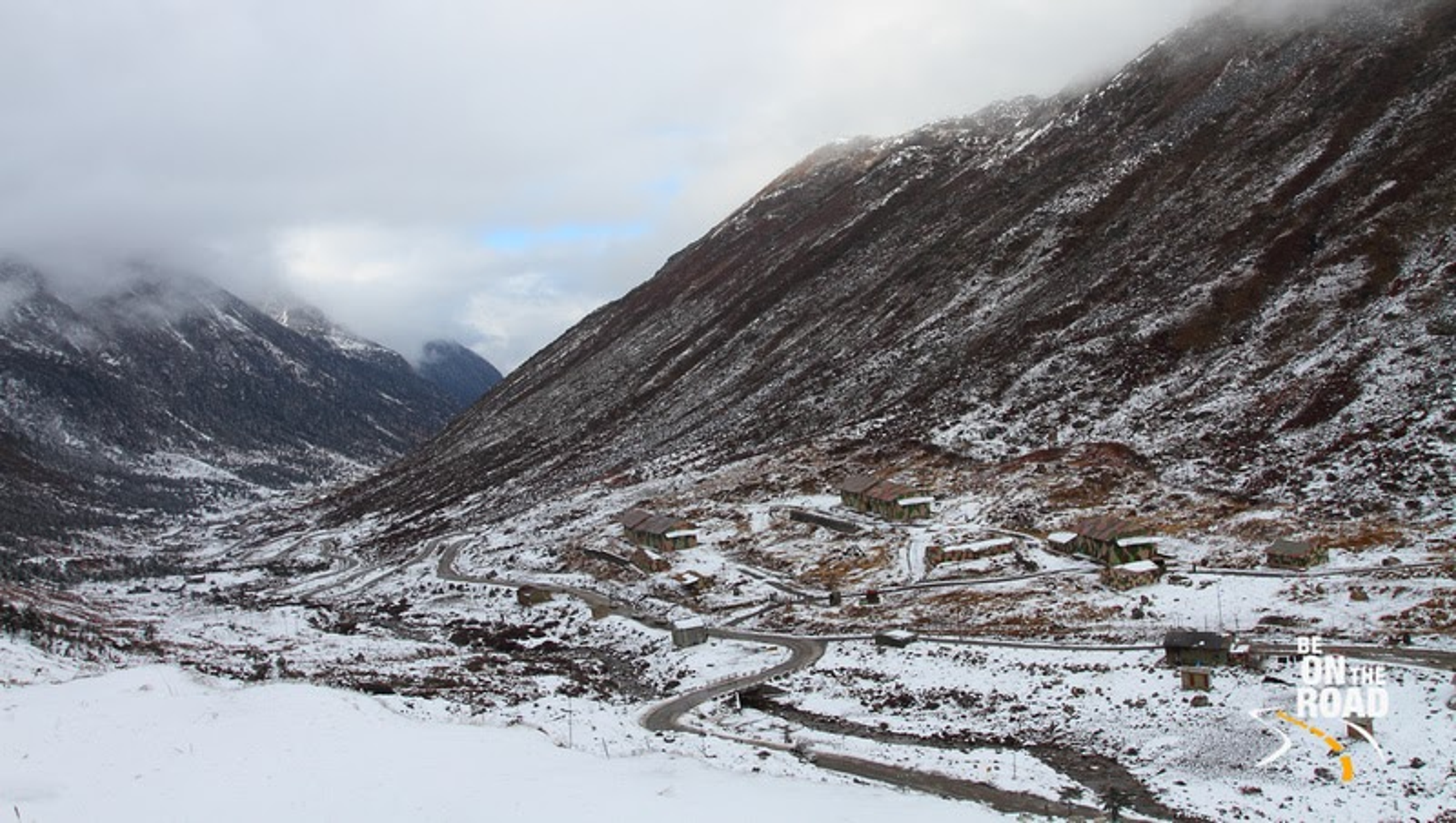 The colorful Sela Pass gateway at 13,700 feet in Arunachal Pradesh, India.]