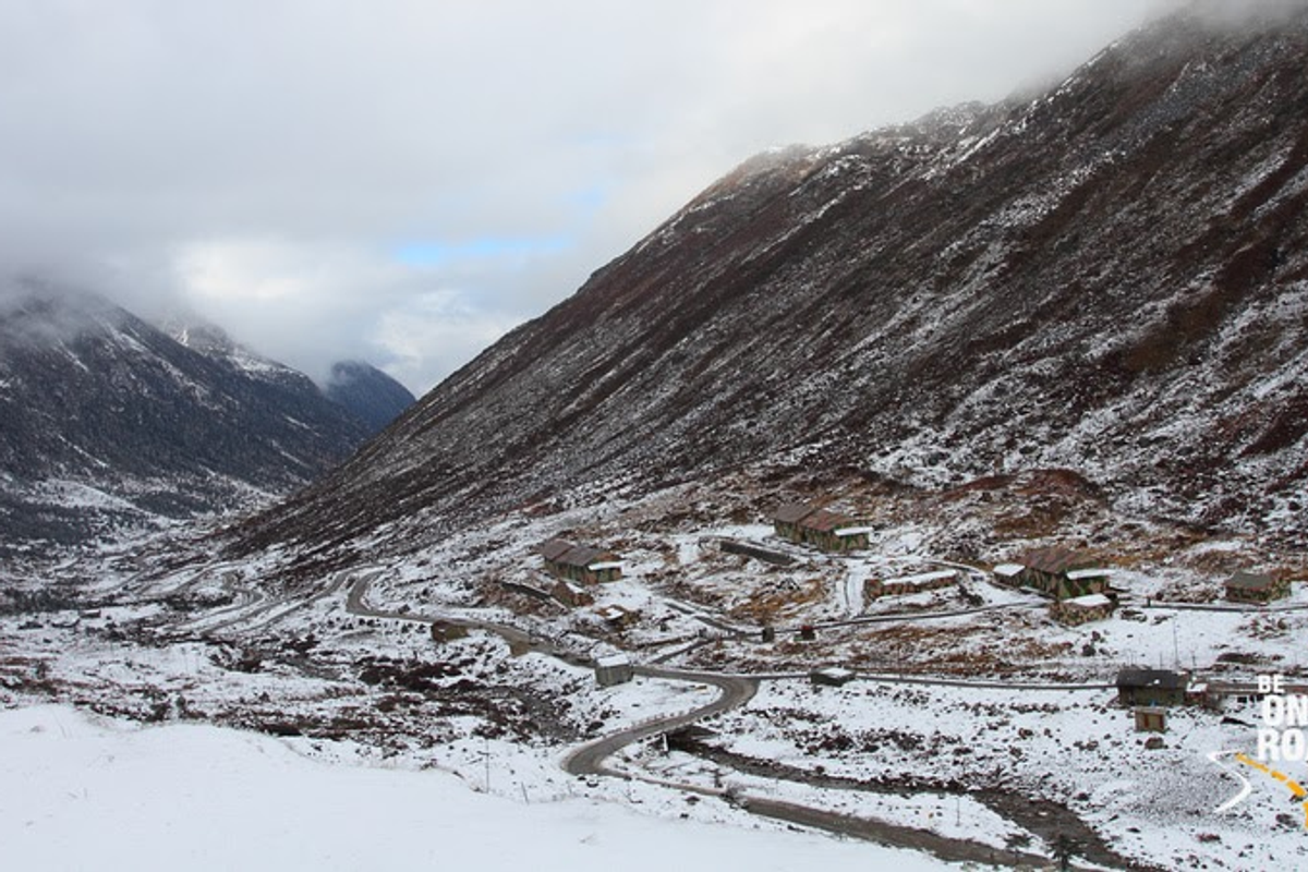 The colorful Sela Pass gateway at 13,700 feet in Arunachal Pradesh, India.]