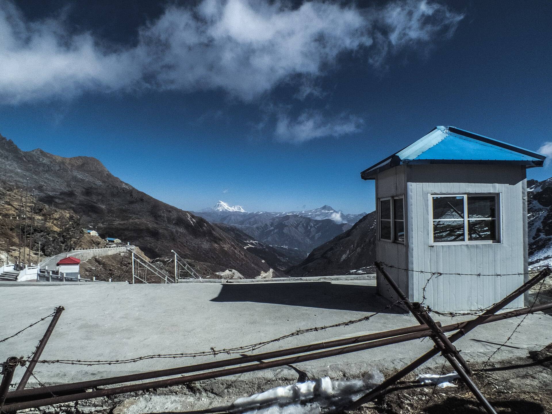 The border post at Nathu La Pass with snow-capped Himalayan peaks behind