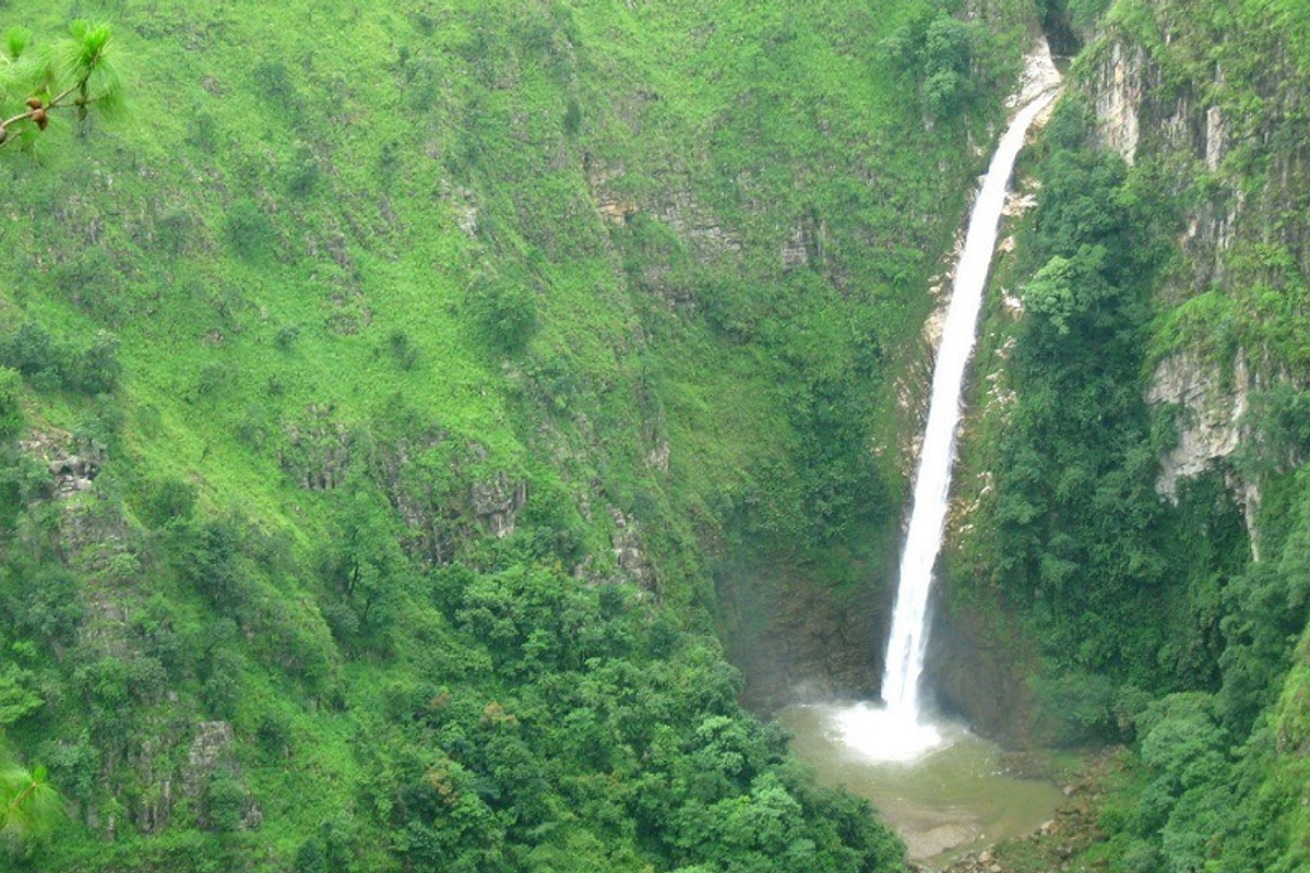 Vertical 96-meter plunge of Sweet Falls in Happy Valley Shillong Meghalaya with pine forest.