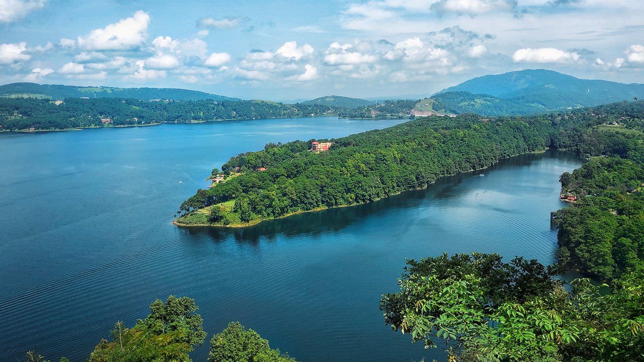 cenic view of Umiam Lake and rolling green hills on the Guwahati to Meghalaya highway.