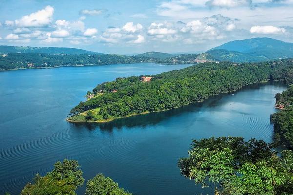 cenic view of Umiam Lake and rolling green hills on the Guwahati to Meghalaya highway.