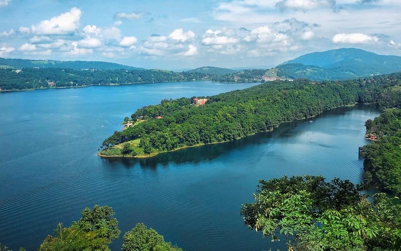cenic view of Umiam Lake and rolling green hills on the Guwahati to Meghalaya highway.