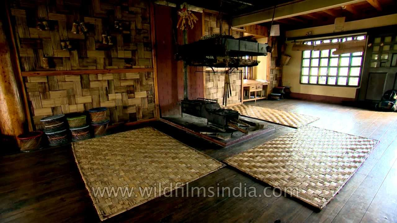 Interior of a traditional Apatani bamboo homestay in Ziro Valley, featuring a central hearth and authentic tribal decor."