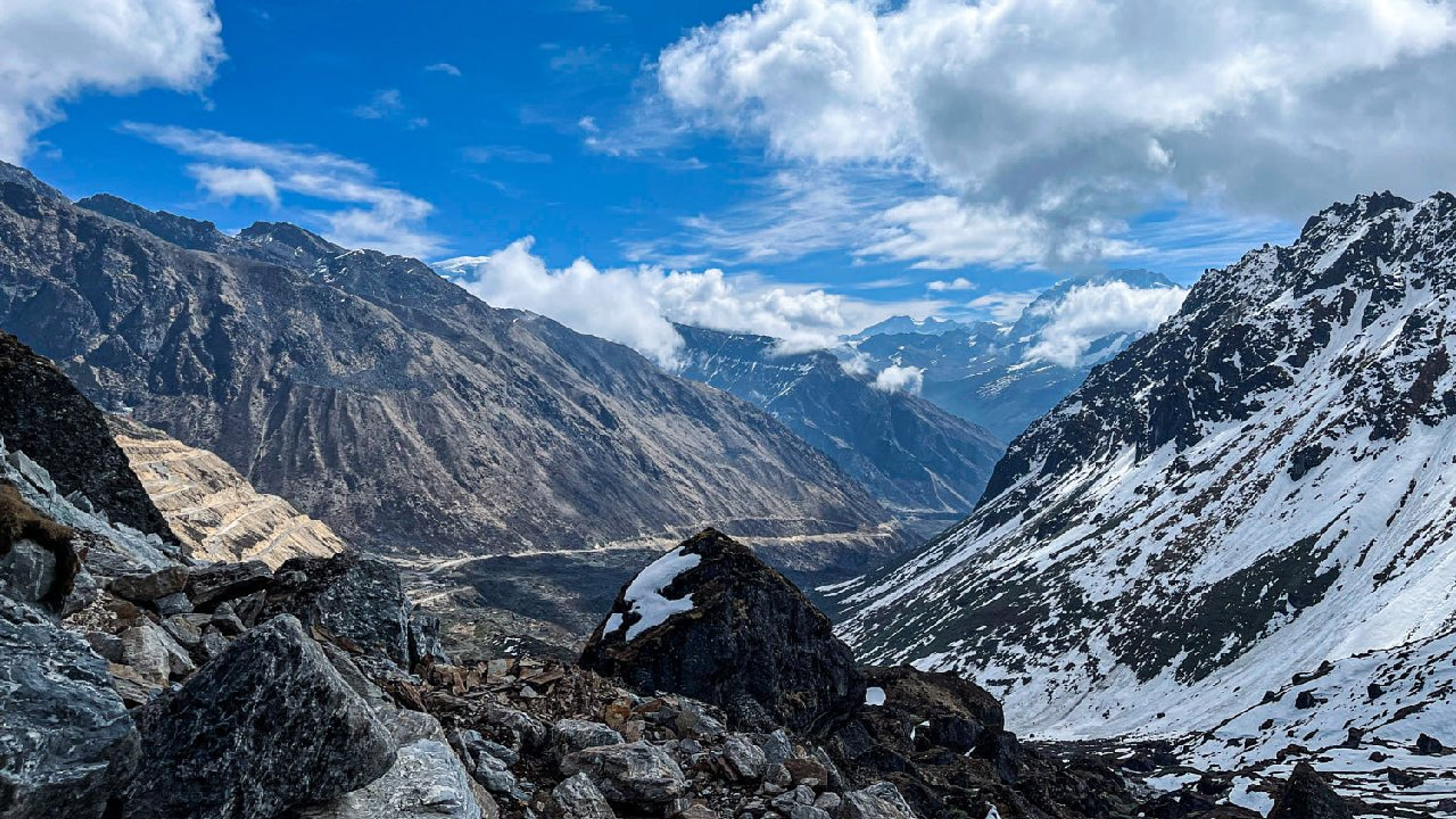 The dramatic black rocks of Kalapatthar are covered in a thick blanket of white snow.