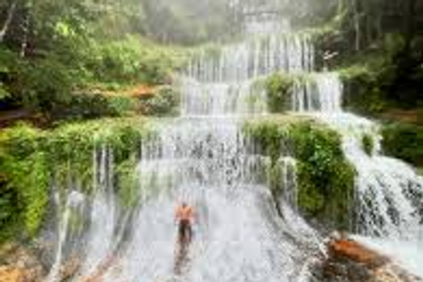 Lush multi-tiered waterfall in a green meghalaya forest.