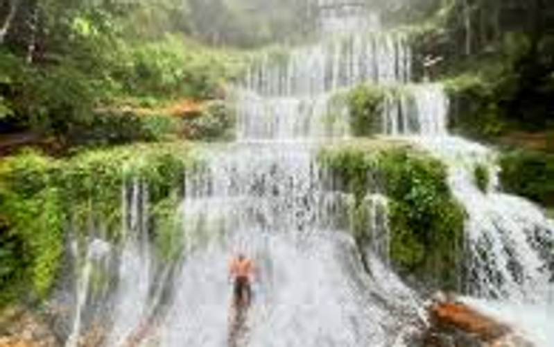 Lush multi-tiered waterfall in a green meghalaya forest.