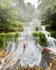 Lush multi-tiered waterfall in a green meghalaya forest.