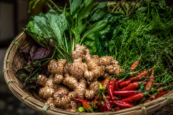 "A cinematic close-up of a traditional Khasi conical bamboo basket filled with fresh organic ginger, chilis, and wild forest greens in Shillong."