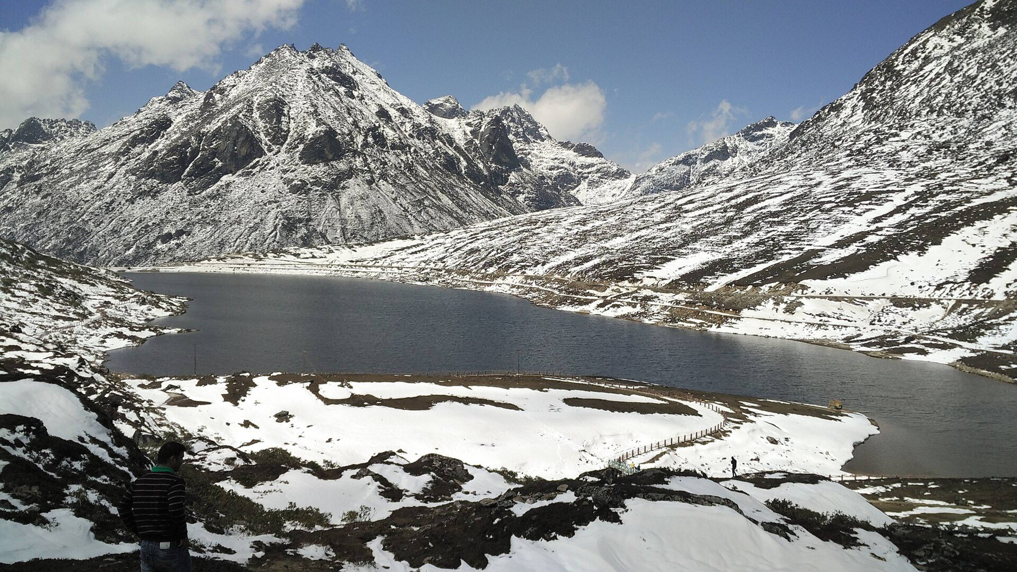 Sela Lake surrounded by snowy mountains near Sela Pass
