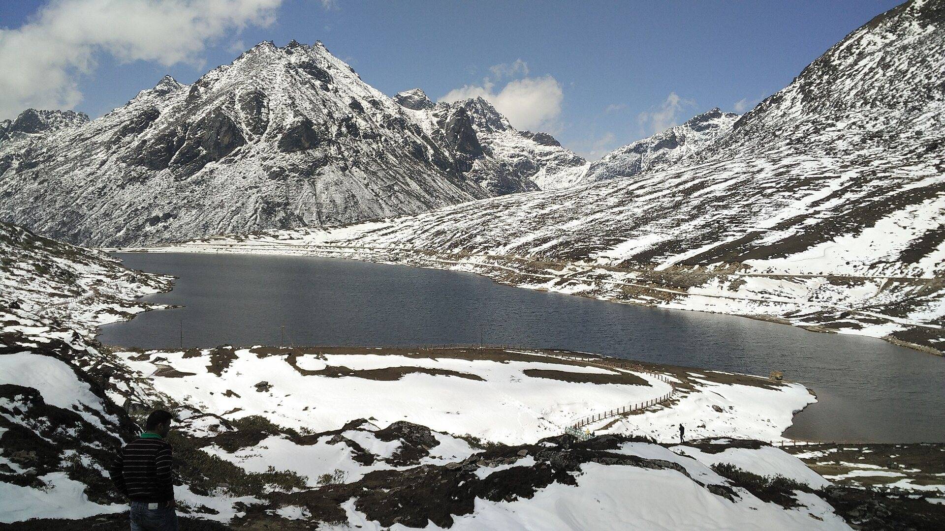 Sela Lake surrounded by snowy mountains near Sela Pass