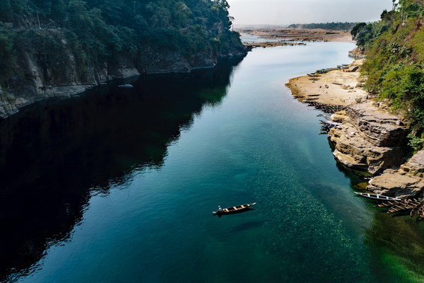 Crystal-clear Dawki River surrounded by hills in Meghalaya, India