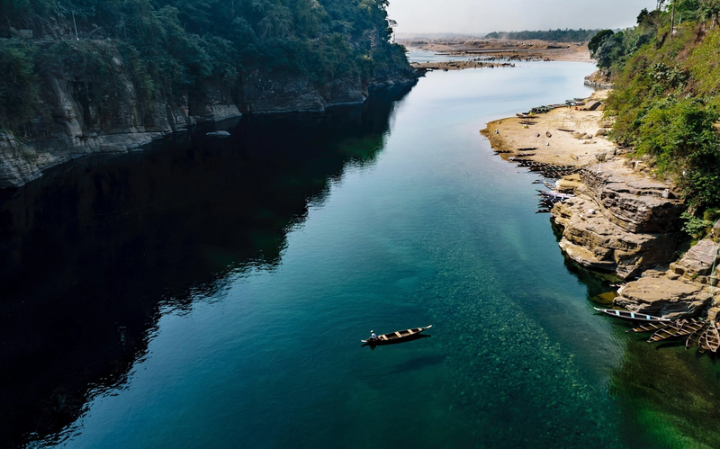 Crystal-clear Dawki River surrounded by hills in Meghalaya, India