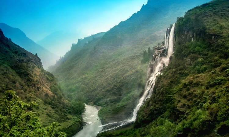The massive Nuranang Falls (Jang Falls) cascading down a rocky cliff in Tawang.