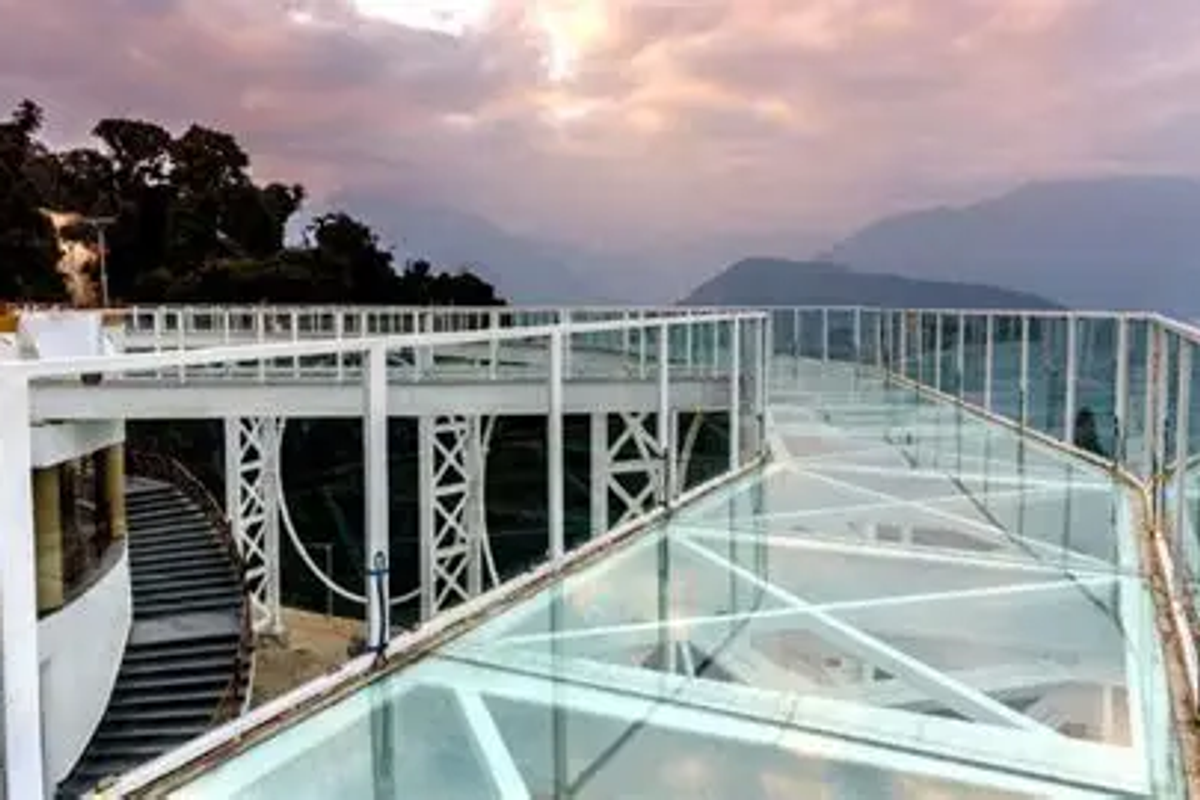 India's first glass skywalk in Pelling West Sikkim showing transparent glass floor over a deep valley.