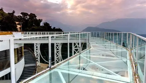 India's first glass skywalk in Pelling West Sikkim showing transparent glass floor over a deep valley.