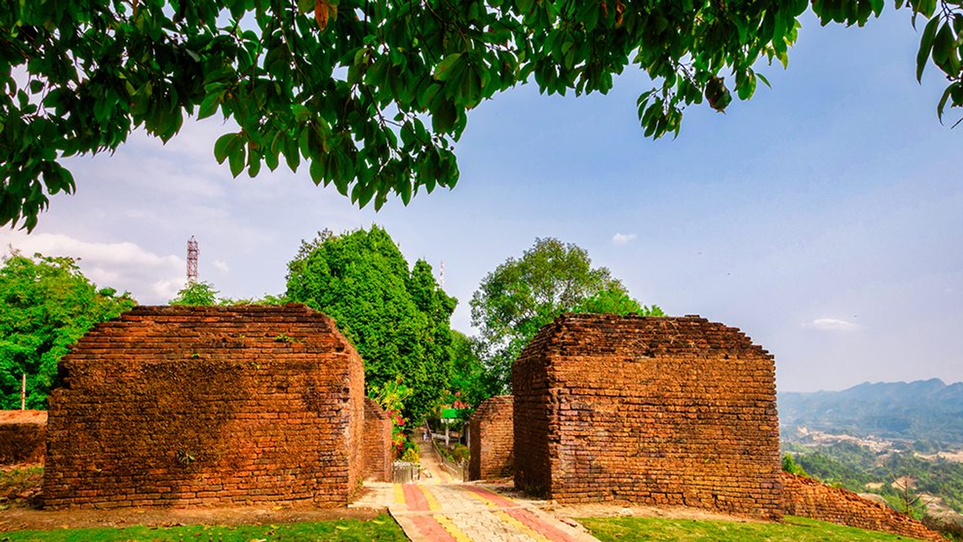 Ita Fort 14th-century brick ruins surrounded by lush green forest in Itanagar, Arunachal Pradesh, with nearby Ganga Lake and tribal culture.