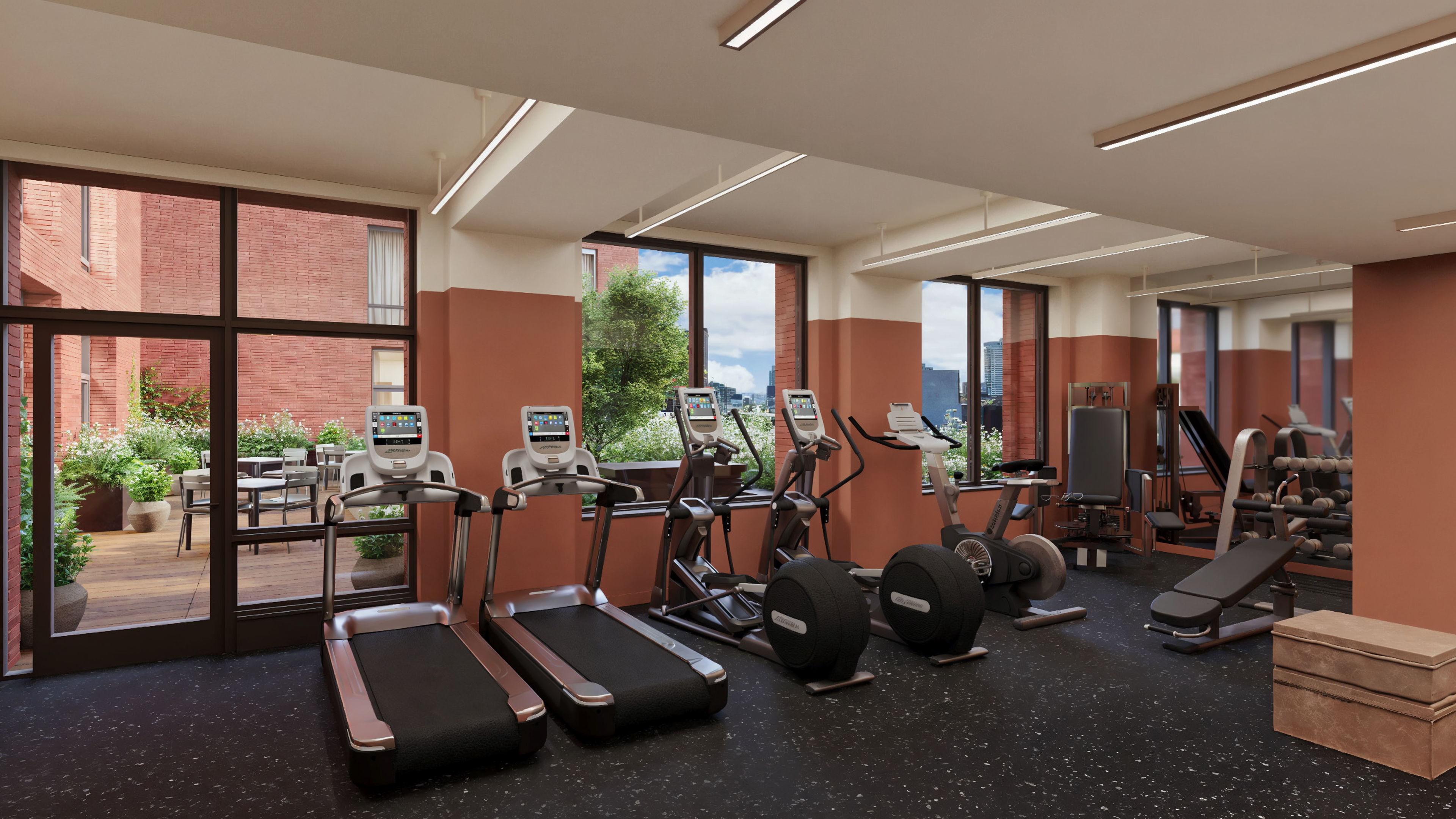 Ray Harlem's state of the art fitness center with high-end exercise machine and views of the Manhattan skyline.