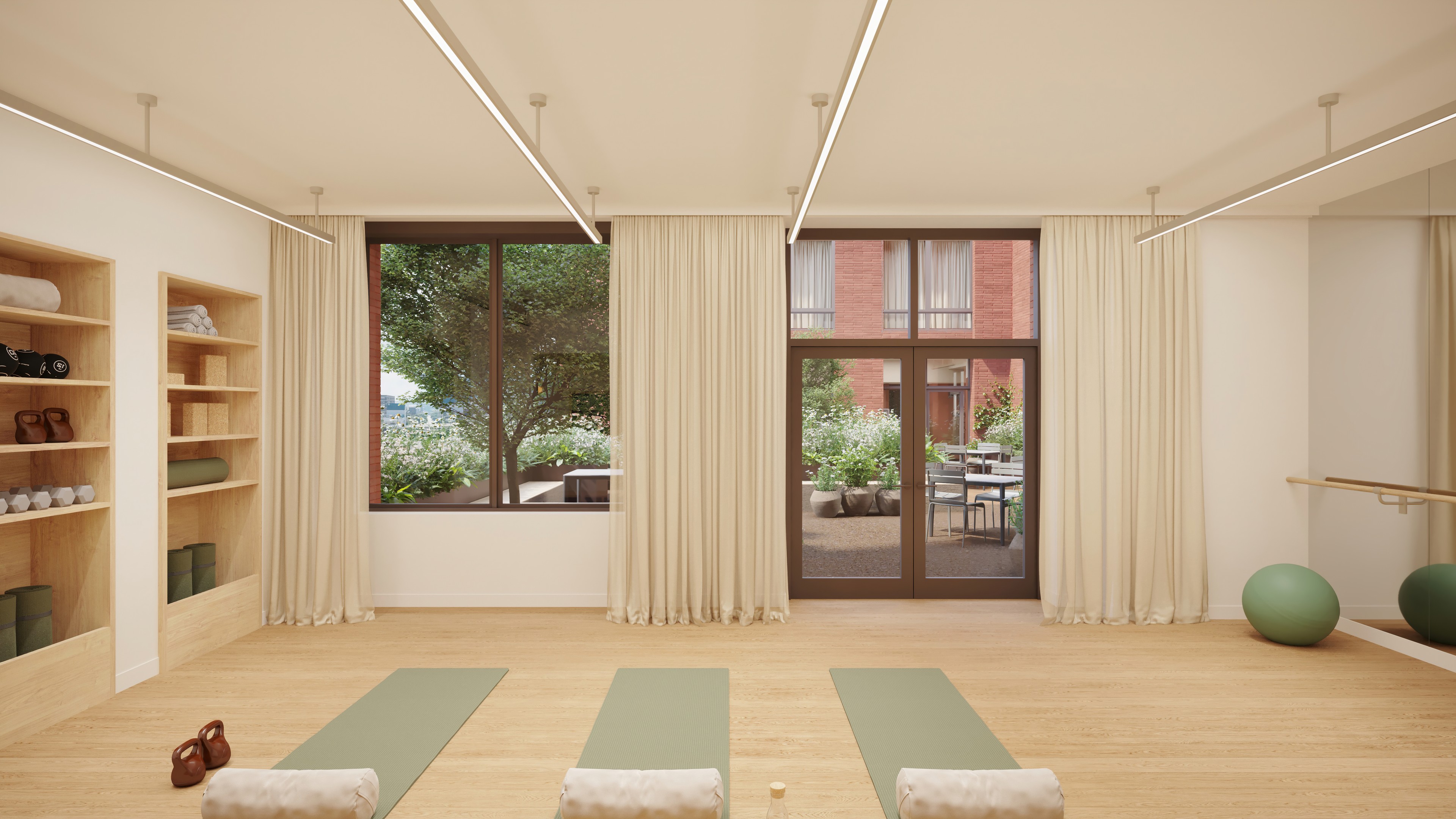 A calm yoga studio with neutral finishes, mats and stretching equipment, featuring doors to an outdoor terrace.