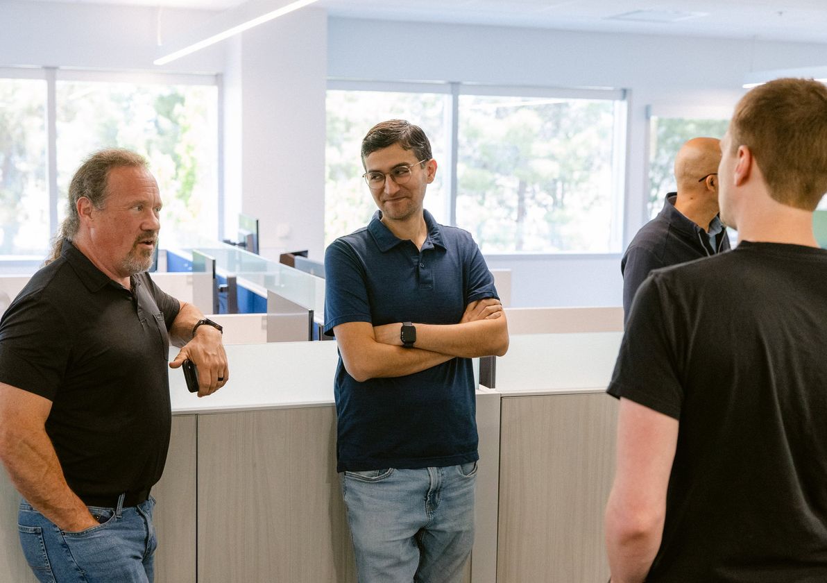 Four colleagues talking in the office